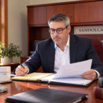 Alan Harrison working in the Sandollar office.