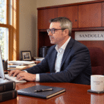 Alan Harrison working in the Sandollar office.